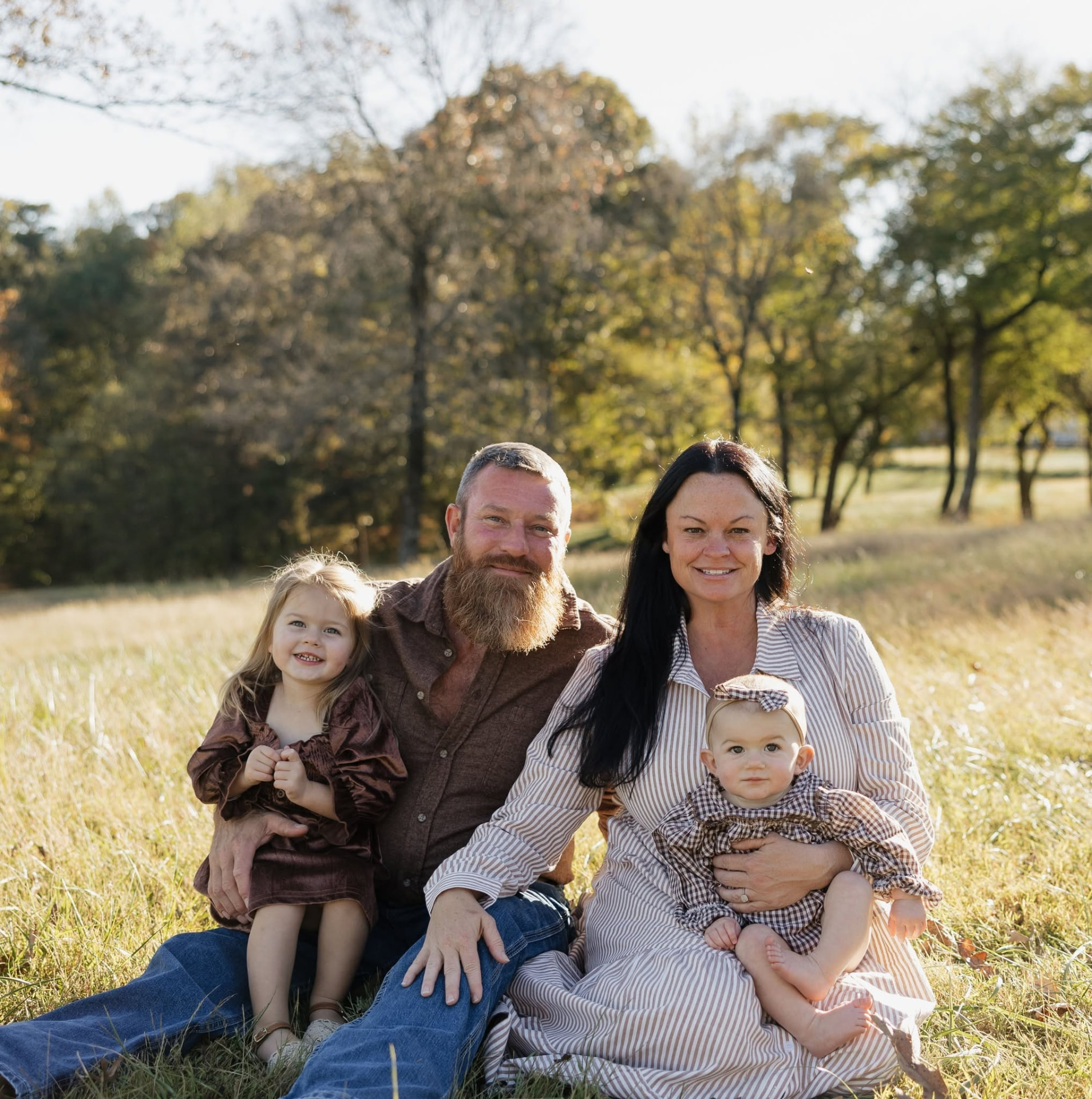 Jason and Jaime Morgan with their two granddaughters on a fall afternoon